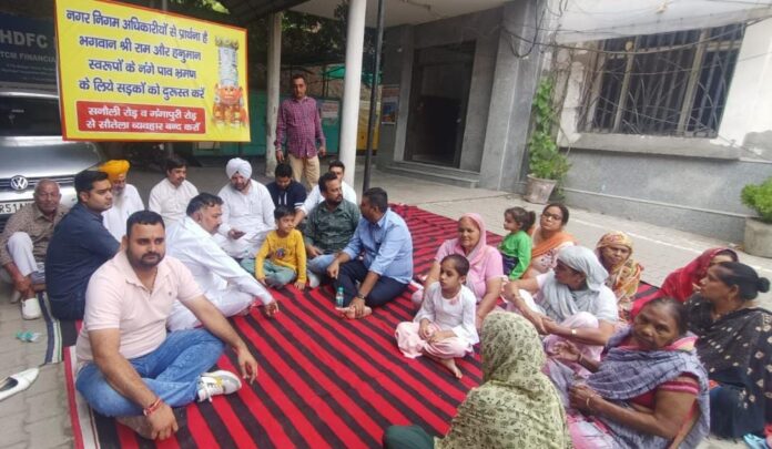 Social workers of the city sat on strike demanding repair of the broken road.