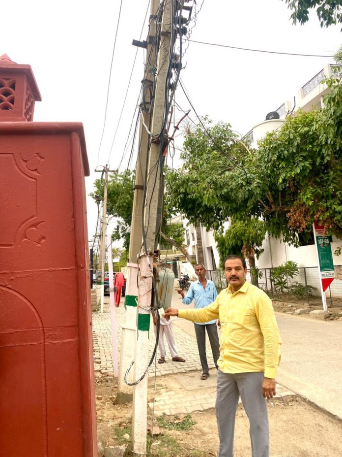 Two electric poles bent towards the road in Block Ditu