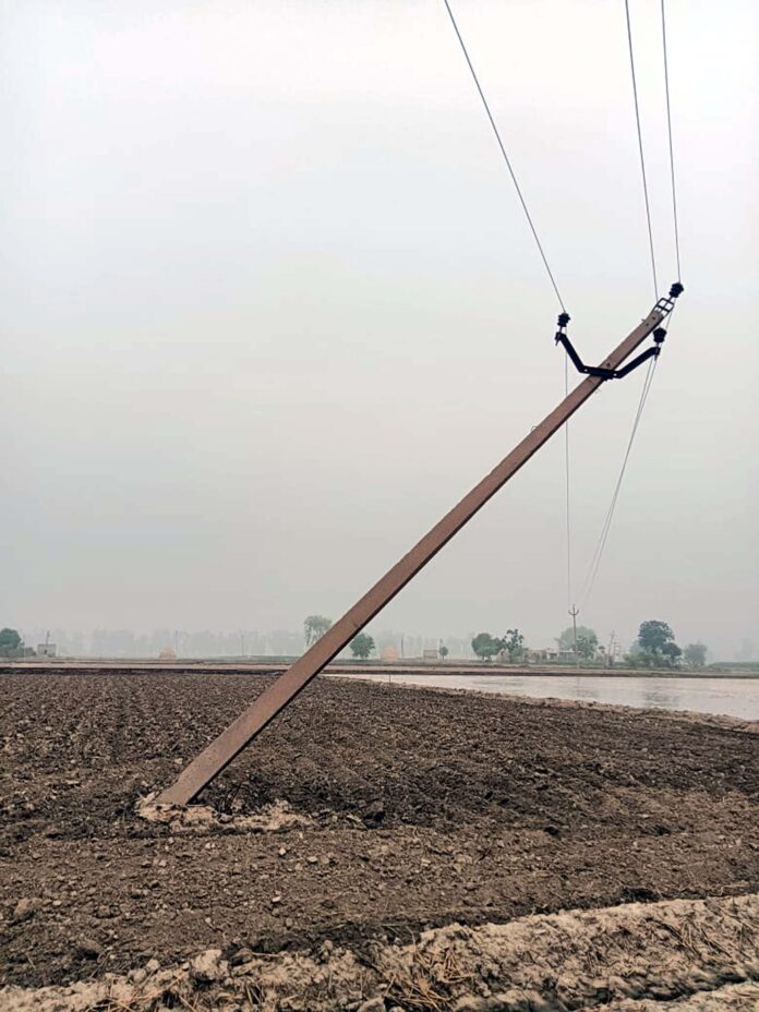 Bent electric pole in the fields, inviting accidents