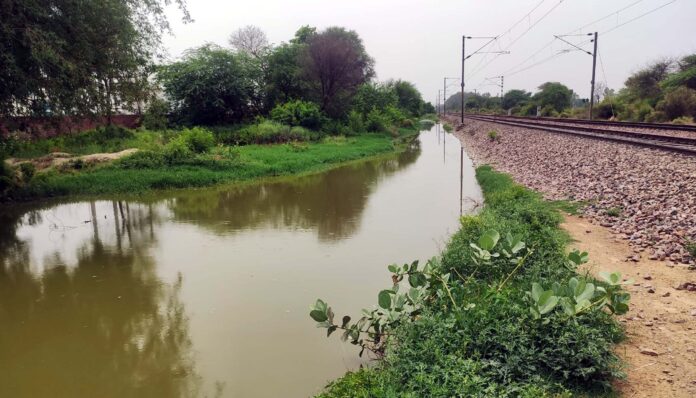 Farmers are not able to reach their fields due to water filled in unpaved roads