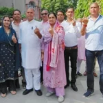 Congress candidate Vijay Pratap casts his vote along with his family in Badkhal Assembly.