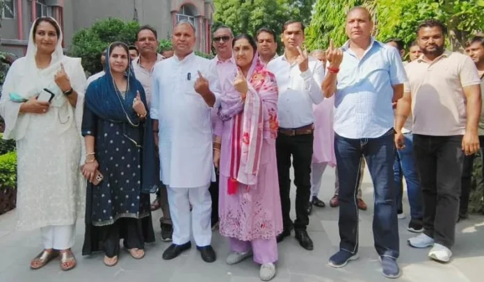 Congress candidate Vijay Pratap casts his vote along with his family in Badkhal Assembly.