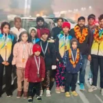 Villagers welcome Vijay with flower garlands after reaching the village after winning the gold medal.