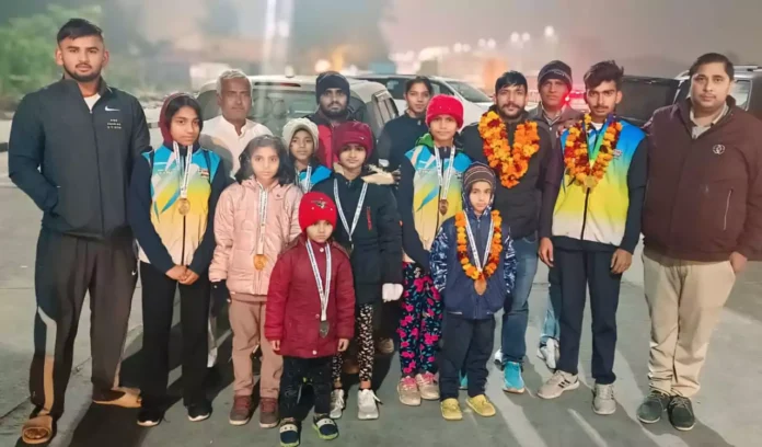 Villagers welcome Vijay with flower garlands after reaching the village after winning the gold medal.